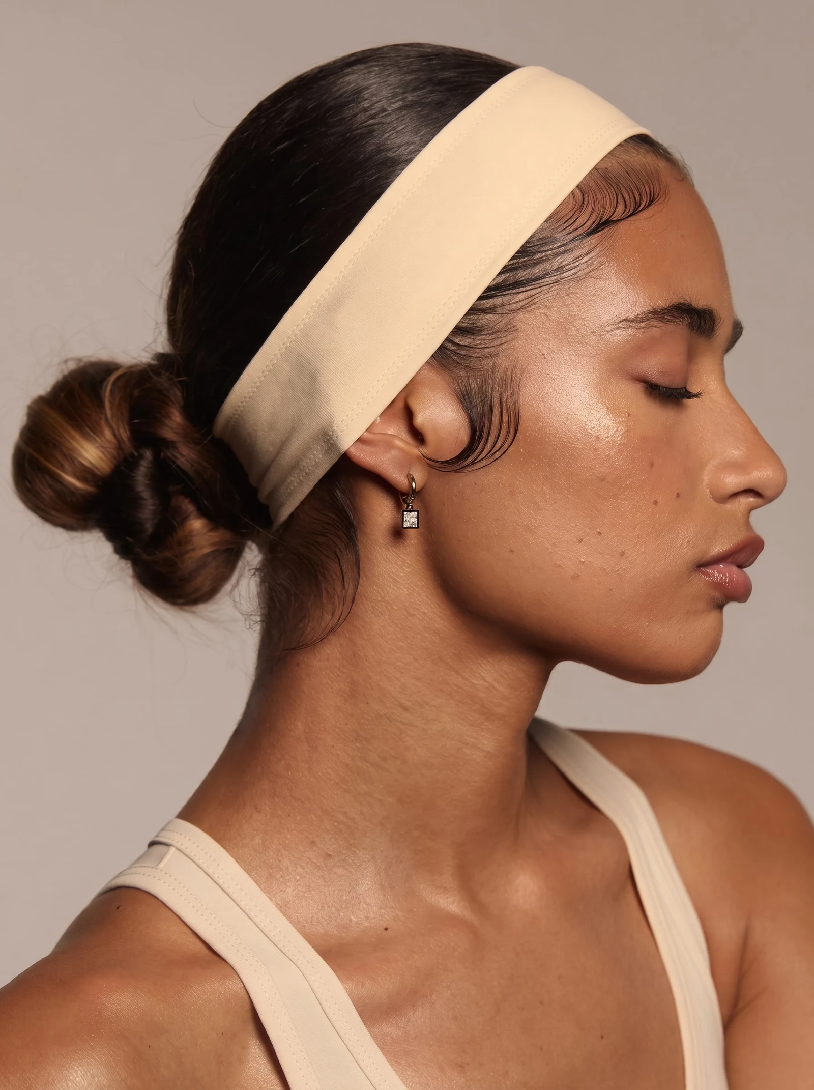 Profile portrait wearing the cream headband
